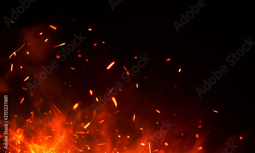 Flying embers and sparks against a black background fiery illumination and dramatic texture