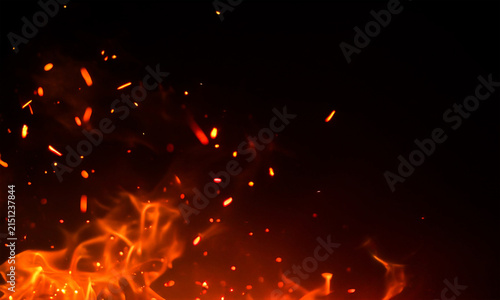Realistic fire sparks and glowing embers on a black background dramatic flame texture