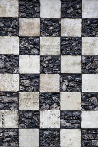 Chequerboard stone pattern on medieval church for use as a background texture