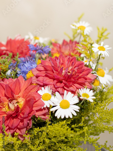 Vertical Close Up of Red Dahlias White Daisies and Summer Greenery