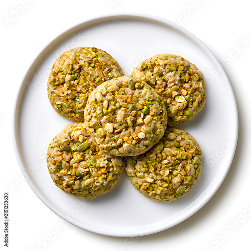 Healthy baking concept with delicious homemade pistachio cookies on a white plate