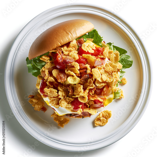 Gourmet Burger topped with Crispy Corn Cereal and Bacon on a White Plate