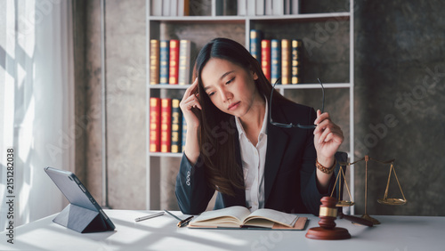 Photography Exhausted Asian Female Lawyer Overwhelmed by Legal Case Work at Office Desk with