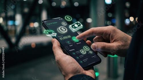 Close-up of hands using smartphone with digital wallet application showing balance and payment options, fintech banking concept with augmented reality money icons.