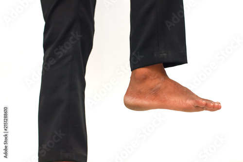 Barefoot Person in Black Pants Demonstrating Balance and Stability with One Foot Lifted