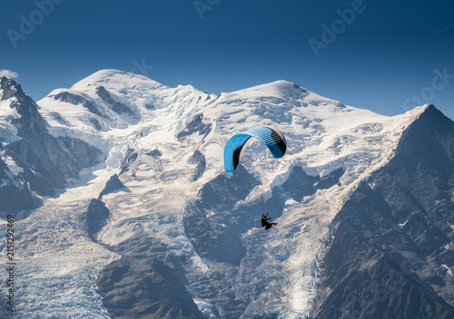 Paraglider Flying In Front Of Mont Blanc Peak 4810m With Glaciers Shot From Brevent High Altitude Extreme Sports Alpine Adventure In French Alps Chamonix Scenic Mountain View Paragliding Experience