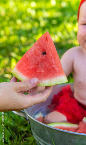 Baby eating watermelon. Selective focus.