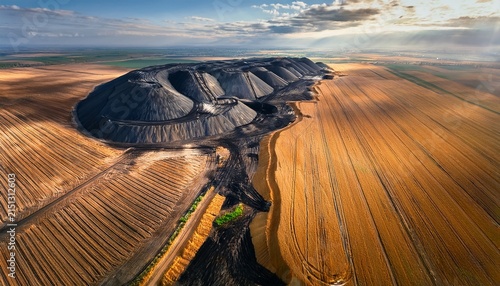 anthropogenic terrain is illustrated by the edge of a wheat field juxtaposed against a cascade of waste piles created by coal mining captured from a drone this anthropogenic terrain reveals stark