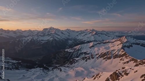 Flying Over Snow Covered Mountain Ranges At Dusk