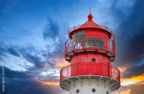 Red Lighthouse Tower at Dramatic Sunset