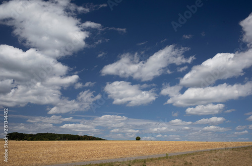 clouds over the field with big blue sky