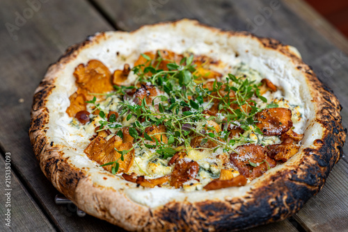 Close up macro of Neapolitan pizza with wild chanterelle mushrooms and blue cheese