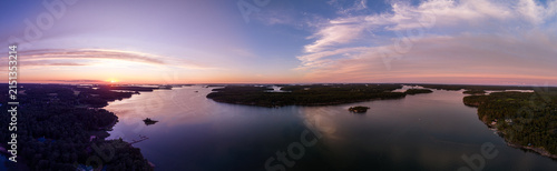 Panoramic aerial view of Finnish Archipelago islands during warm golden hour sunset