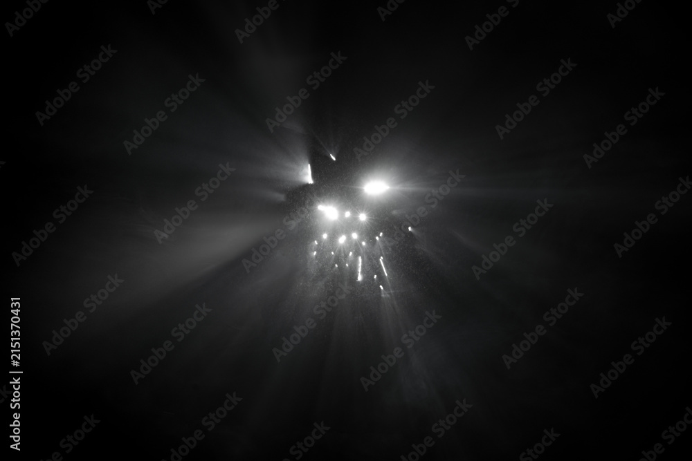 Obraz premium Abstract fog. White light rays, mist or smog moves on black background. Beautiful swirling gray smoke. Mockup for your logo.