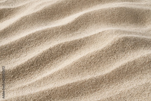 Textural Sand Dunes Close Up with Wavy Patterns on a Sunny Beach Surface