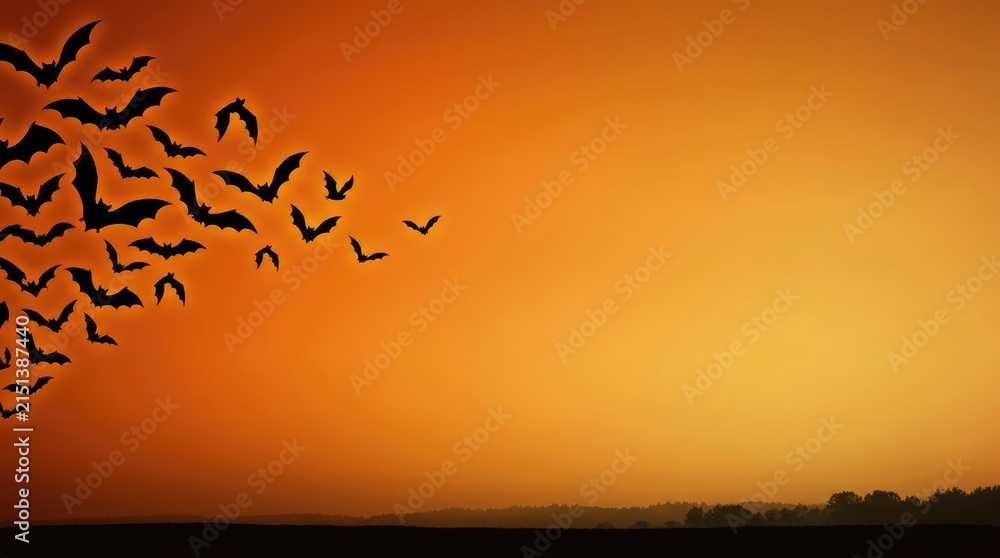 Fototapeta premium Spooky Halloween orange sky background with heavy swarm of bats and copy space