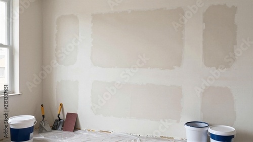 Renovator Patching Plaster On Living Room Wall