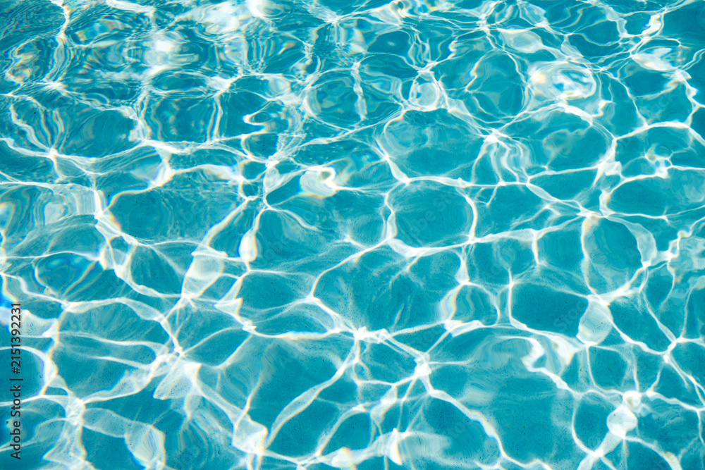 Fototapeta premium Summer vacation at ocean shore. Blue ocean rippled water texture reflection. Ripple water in summer pool. Sea surface background. Vacation resort water background. Sea beach