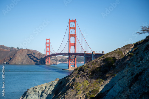 Golden Gate Bridge stands over the water in California during a clear day with blue skies