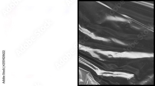 Fotografía Crumpled plastic wrap texture, black and white wrinkled cellophane background, g