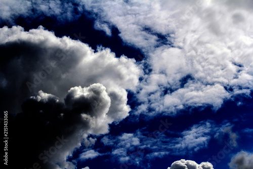 A vibrant blue sky dotted with fluffy white clouds