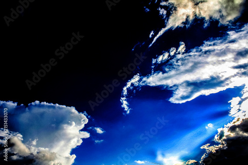 A vibrant blue sky dotted with fluffy white clouds
