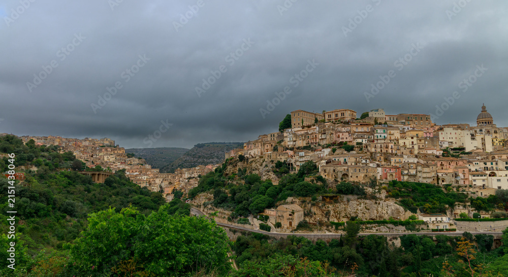 Fototapeta premium Panoramic view of an ancient Italian hilltop town under a cloudy sky