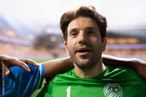 Obraz na plátně Goalkeeper in a green jersey sings the national anthem with teammates at the pre-match ceremony, standing in a respectful lineup and showing team spirit before the football game begins on the pitch