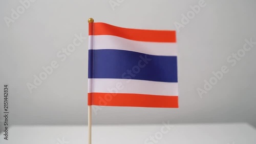 Small Thailand Flag Waving on White Table Desk Stand Isolated on Grey Background