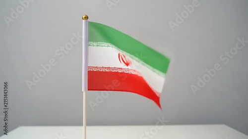 Small Iran Flag Waving on White Table Desk Stand Isolated on Grey Background