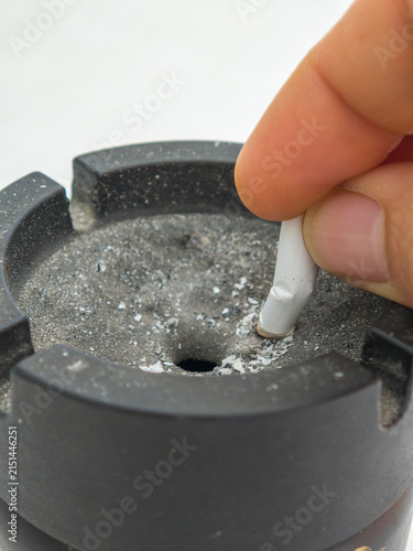 Quadro su tela Hand Putting Out a Lighted Cigarette in a Black Ashtray