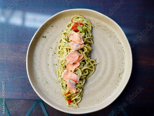Top-down view of Japanese-Italian fusion seaweed pesto carbonara spaghetti with pink salmon toppings