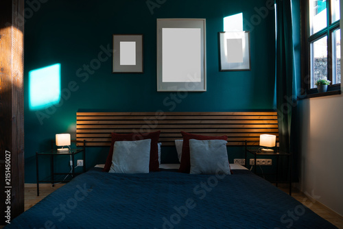 Foto Three blank frames above bed in dark teal bedroom