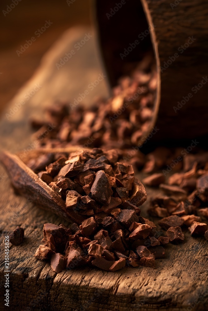 Fototapeta premium Cracked Cocoa Bean with Raw Nibs on Rustic Wood