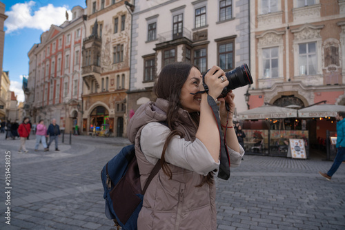 Female traveler taking street photos in historic Prague