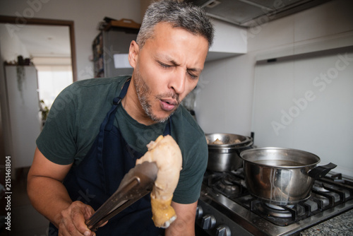 Man Tasting Hot Food Fresh from the Pot