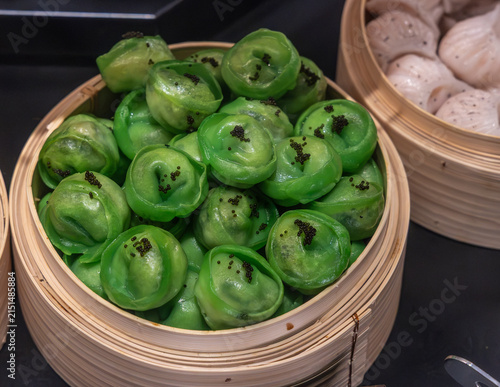 Fresh, handmade steamed dumplings on display ready for sale.