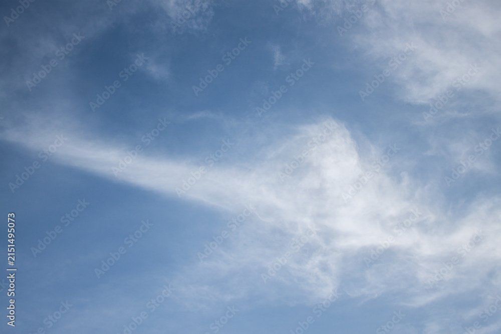 Fototapeta premium blue sky with a dramatic scattering of white clouds. blue sky background.