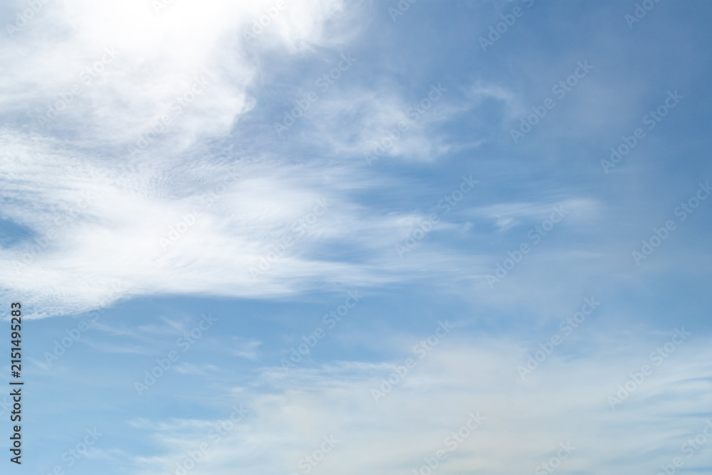 Obraz premium blue sky with a dramatic scattering of white clouds. blue sky background.