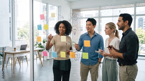 Collaborative Team Brainstorming Session with Post-it Notes in Modern Office Space Fostering Creativity and Innovation Among Colleagues