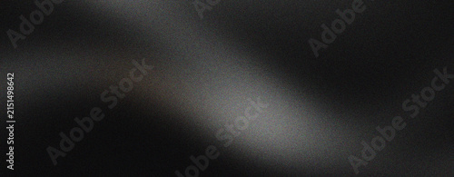 Elegant black silk fabric texture with soft waves. Luxurious dark satin material background for fashion and beauty branding. Smooth charcoal textile surface with subtle lighting and shadows.