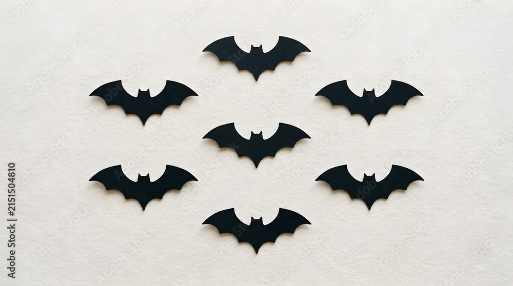 Fototapeta premium Many black paper bats flying in a group for a spooky halloween holiday decoration project
