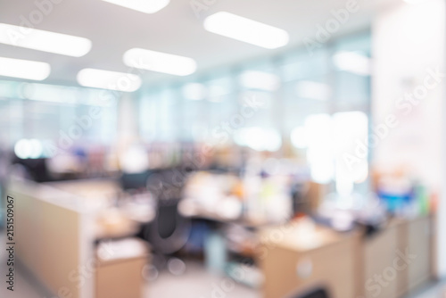 Abstract blurred modern open plan office interior with workstations and ceiling lights