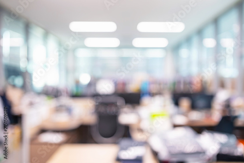 Abstract blurred modern open plan office interior with ceiling lights and desks