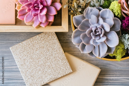 Weekly planner setup on a wooden table with seasonal greenery and a tray under gentle diffused daylight, generous copy space.