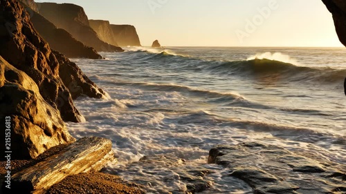 Ocean waves crashing on rocky coastline cliffs.