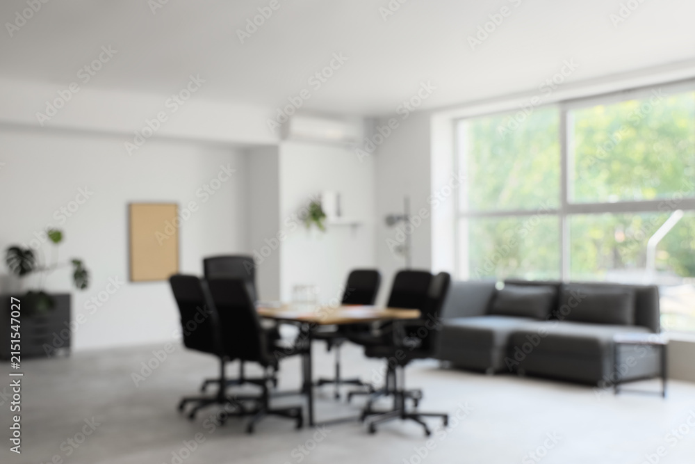 Fototapeta premium Blurred view of conference hall with table and sofa