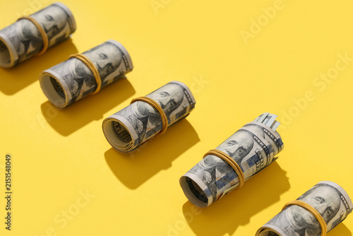 Rolled dollar banknotes on ...