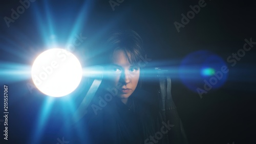 Woman Holding Flashlight With Lens Flare In Dark Room Looking At Camera