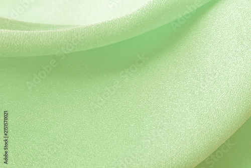 Fotografía Wavy and flowing light pastel green silk satin crepe fabric as background